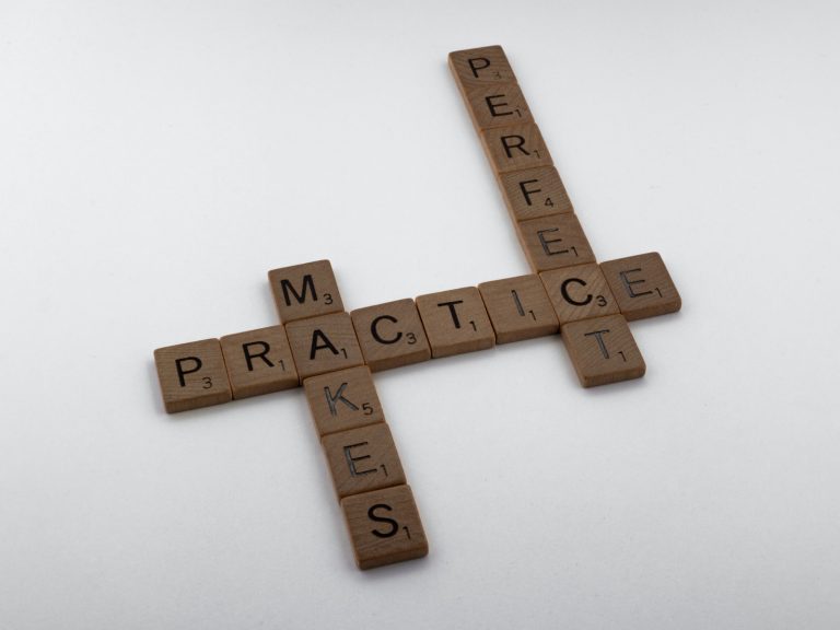 brown wooden cross on white surface