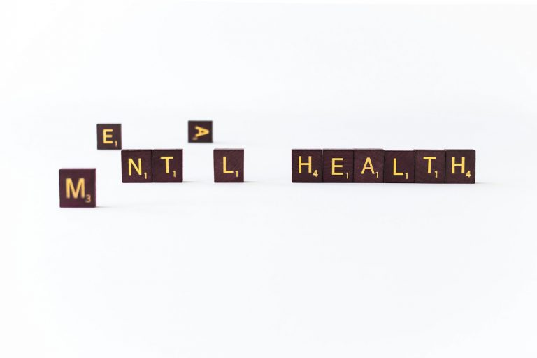 a set of wooden blocks spelling the word mental